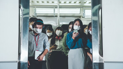 Crowd of people wearing face mask on a crowded public subway train travel . Coronavirus disease or...