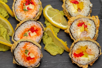 japanese sushi food. Maki ands rolls with tuna, salmon, shrimp, crab and avocado. Top view of assorted sushi. Rainbow sushi roll, uramaki, hosomaki and nigiri. Assorted sushi