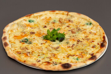 Delicious pizza with cheese and basil on table. op view tasty italian pizza. Four cheese pizza quattro fromaggi with basil leaf.