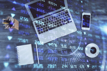 Double exposure of forex chart drawing over table background with computer. Concept of financial research and analysis. Top view.