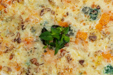 Delicious pizza with cheese and basil on table. op view tasty italian pizza. Four cheese pizza quattro fromaggi with basil leaf.