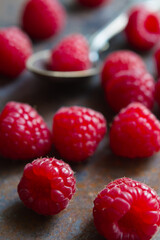Raspberry berries on a rough surface in a vintage spoon