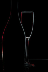 
Contours of a bottle and glasses on a black background