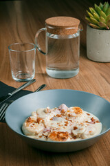 Cottage cheese pancakes on table. Cottage cheese pancakes. Cottage cheese pancakes on a blue plate on a wooden table.