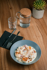 Cottage cheese pancakes on table. Cottage cheese pancakes. Cottage cheese pancakes on a blue plate on a wooden table.