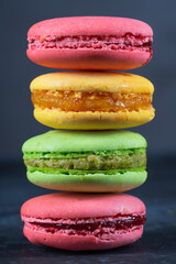 Colorful macarons on black background