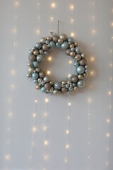 Christmas wreath of Christmas toys on a white background with lights