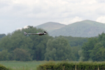 Fototapeta na wymiar Remote control flying wing drone with malvern hills background