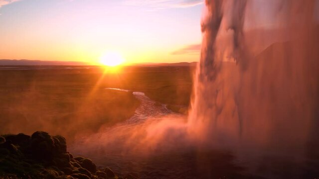 Seljalandsfoss spectacular waterfall in Iceland at Sunset Popular tourist destination Golden hour
