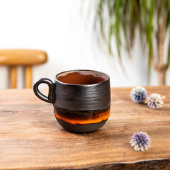 Obraz na płótnie Canvas handmade ceramic coffee cup on wooden table
