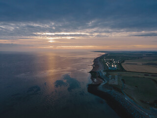 Drone aerial shot of Remains of Reculver church towers at early october sunrise  early october...