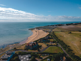Drone aerial shot of Empty Kingsgate Beach and Castle on the cliffs above the Bay, on cloudy autumn...