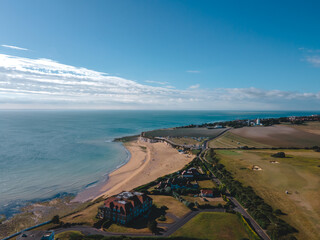 Drone aerial shot of Empty Kingsgate Beach and Castle on the cliffs above the Bay, on cloudy autumn...