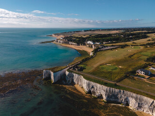 Drone aerial shot of Empty Kingsgate Beach and Castle on the cliffs above the Bay, on cloudy autumn...