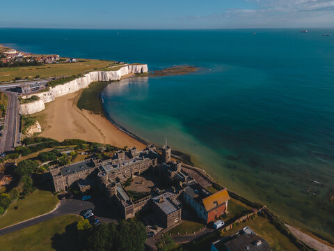 Drone aerial shot of Empty Kingsgate Beach and Castle on the cliffs above the Bay, on cloudy autumn morning.