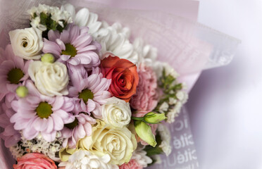 A bouquet of flowers of delicate colors on white background