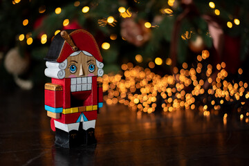 Decorated Christmas tree on blurred new year's background . children's nutcracker toy stand near the Christmas tree. Happy New Year 2020. winter holidays
