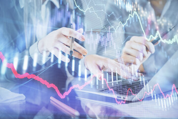 Multi exposure of man and woman working together and financial chart hologram. Business concept. Computer background.