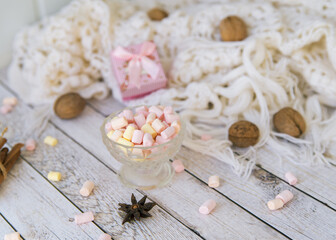 A lot of marshmallow, sweater, cinnamon, presents . Cozy christmas composition.Winter time. Christmas holiday concept.