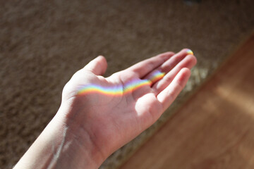 hand and rainbow in the room