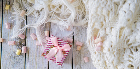 A lot of marshmallow and white scarf on a white table before christmas eve
