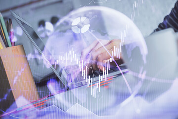 Double exposure of woman hands typing on computer and forex chart hologram drawing. Stock market invest concept.