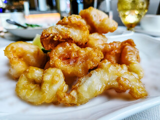 Traditional Italian dish Fritto Misto di Pesce - deep-fried seafood on a plate.