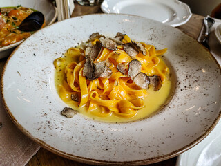 Homemade pasta Fettuccine with cream sauce and truffle are on the plate.