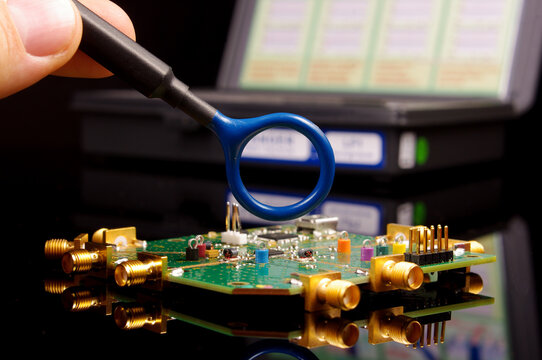 EMC engineer analyzing PCB using near-field probe
