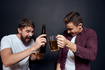 Two drunk friends drinking beer rest fun dark background