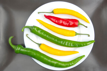 yellow, red and green hot chili on a plate. Pepper. Vegetable vitamin food.