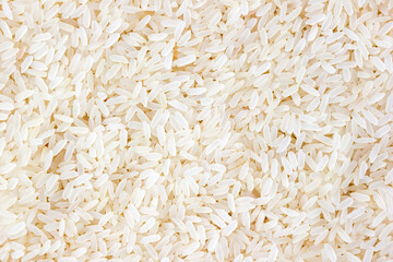 Grains of parboiled long grain rice close-up. Background for wallpapers and banners. Top view