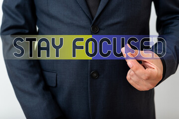 Writing note showing Stay Focused. Business concept for Be attentive Concentrate Prioritize the task Avoid distractions Model with pointing hand finger symbolizing navigation progress growth