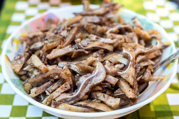 A cooked dish made from pork ears. Delicacy. The dish is on our table.