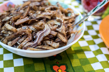 A cooked dish made from pork ears. Delicacy. The dish is on our table.