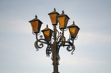 Fototapeta na wymiar old wrought iron street lamp close up