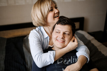 Obraz premium Man and woman hugging and having fun on the couch