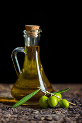 olive oil and fresh olives on the old table
