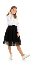 A little girl fixes her hair.The concept of beauty and fashion