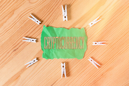 Text sign showing Cryptocurrency. Business photo text form of currency that exists digitally has no central issuing Colored clothespin papers empty reminder wooden floor background office