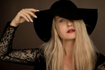 Classy blonde woman wearing a hat, artistic film portrait for fashion campaign and beauty brand...