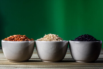 Black venus, red and integral rice pile isolated on wooden table background in Brazil