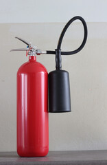 Obraz premium fire extinguisher container on white wall in the building.