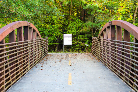 A Bridge Over A River With Metal Railing And Lush Green Trees  At The Chattahoochee River National Recreation Area In Sandy Springs Georgia