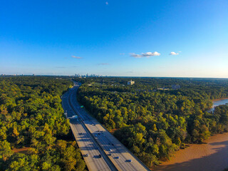 a stunning aerial shot of vast miles of lush green trees, the freeway, the Chattahoochee river and...