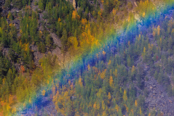 The nature of the Magadan region. Beautiful rainbow on the background of autumn hills