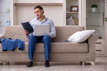 Young male employee working from the house