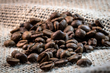 rosted grains brazilian coffee on jute background in Brazil