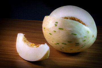 Melon of the snow leopard or matisse or dino variety on a wooden table in brazil
