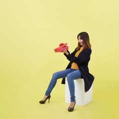 Young woman holding a gift box